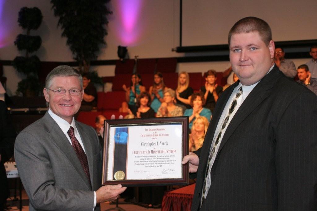 Chris Norris, right, is presented his CIMS by General Overseer Raymond F. Culpepper.
