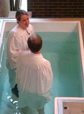 The Rev. Elizabeth Hagan prepares to baptize parishioner Steve Robinson. 