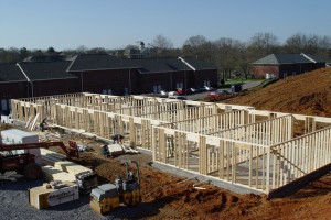 Crews work on one of three new housing residences currently under construction on the Lee University campus. In the background are two of the buildings of Brinsfield Row.