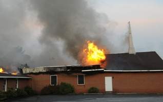 centerville-fire Flames shoot through the roof of the Centerville Church of God.