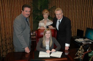 dsc_0534 Tara Hill, seated, signs with SpiritSound. Standing left to right are Larry Horrell, Paula Hil and Tim Hill.
