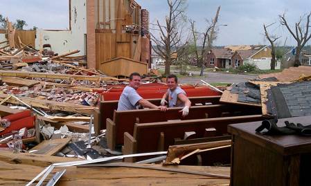 imageserverdb Two men take a break on one of Empire Baptist Church's red pews, some of the few items left untouched by the EF5 tornado that destroyed the church's building and much of Joplin, Mo., Sunday, May 22.