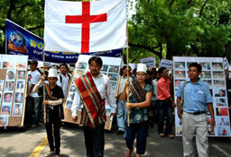 Thousands of Burmese refugees escaping Christian persecution take part in a procession.