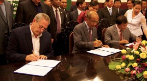 mou_signing_for_bac_project Dr. Fred Garmon, left, signs the Memorandum of Understanding with Cambodian officials.