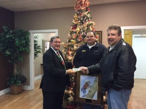 SMCH Communications Director Coleman Peacock, left, accepts a check from Joey Gann and Lee Harrson from Swaggerty Sausage.