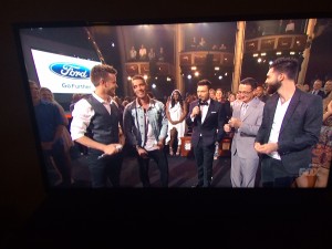 (L-R) Clark Beckham, Nick Fradiani and AI host Ryan Seacrest are joined by the mentors Jimmy Phillips (Beckham) and Nick Abraham (Fradiani) (TV screen shot; Click to enlarge)