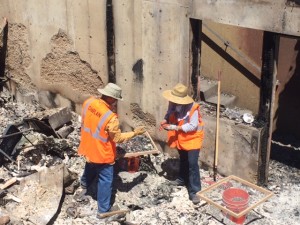 Chaplains assist in sifting ashes looking for a home owner's belongings.