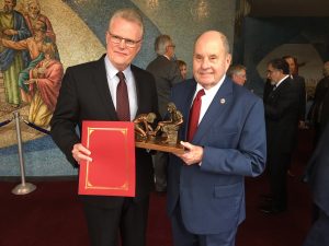 General Overseer Tim Hill, left, accepts a letter of affirmation from Cleveland Mayor Tom Rowland. 