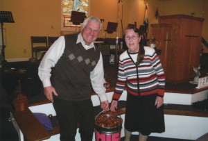 Doug Losch and Vina Duncan with the bucketful of pennies.
