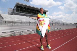 Pardon Ndhlovu wraps himself in his native flag of Zimbabwe. He runs in the Olympic marathon this Sunday.(click photo to enlarge)